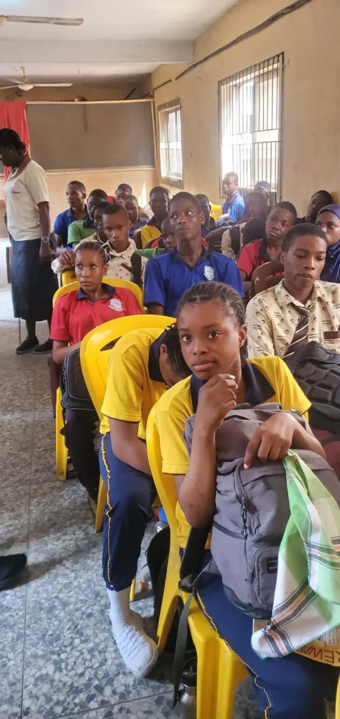 Children in a classroom listening to a lesson by CACI