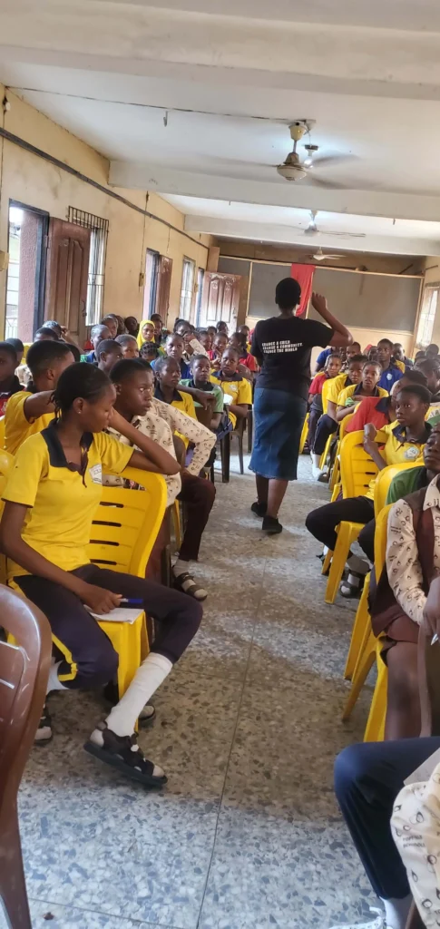 Children in a classroom listening to a lesson by CACI