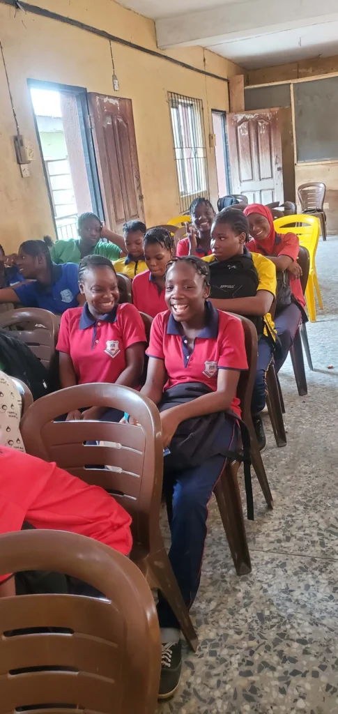 Children in a classroom listening to a lesson by CACI