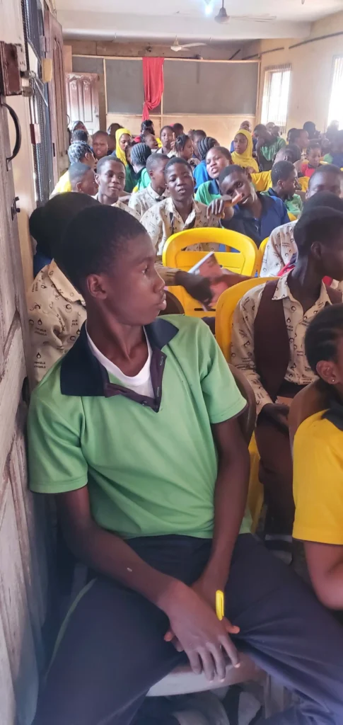 Children in a classroom listening to a lesson by CACI