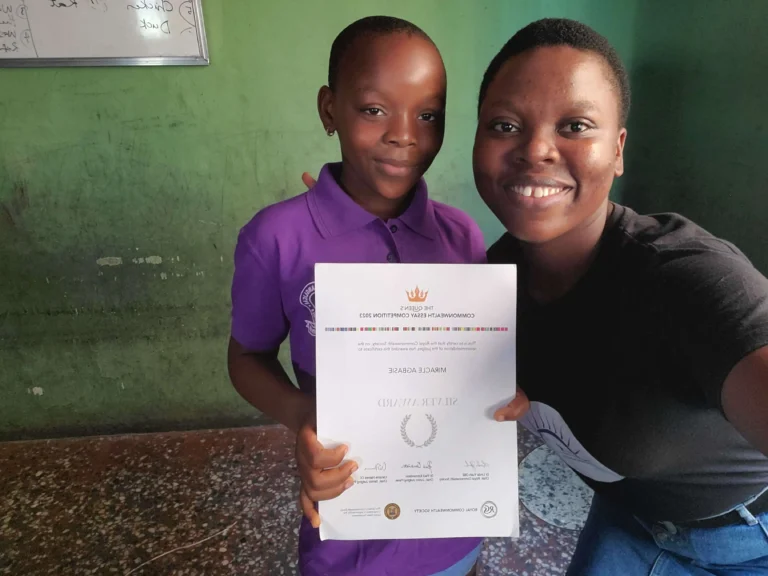 Winner of CACI essay competition poses with Blessing Awamba, CACI Founder.