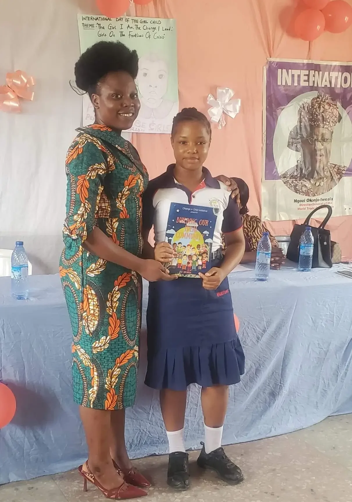 Student with Building Our Ideal Community Book created by CACI